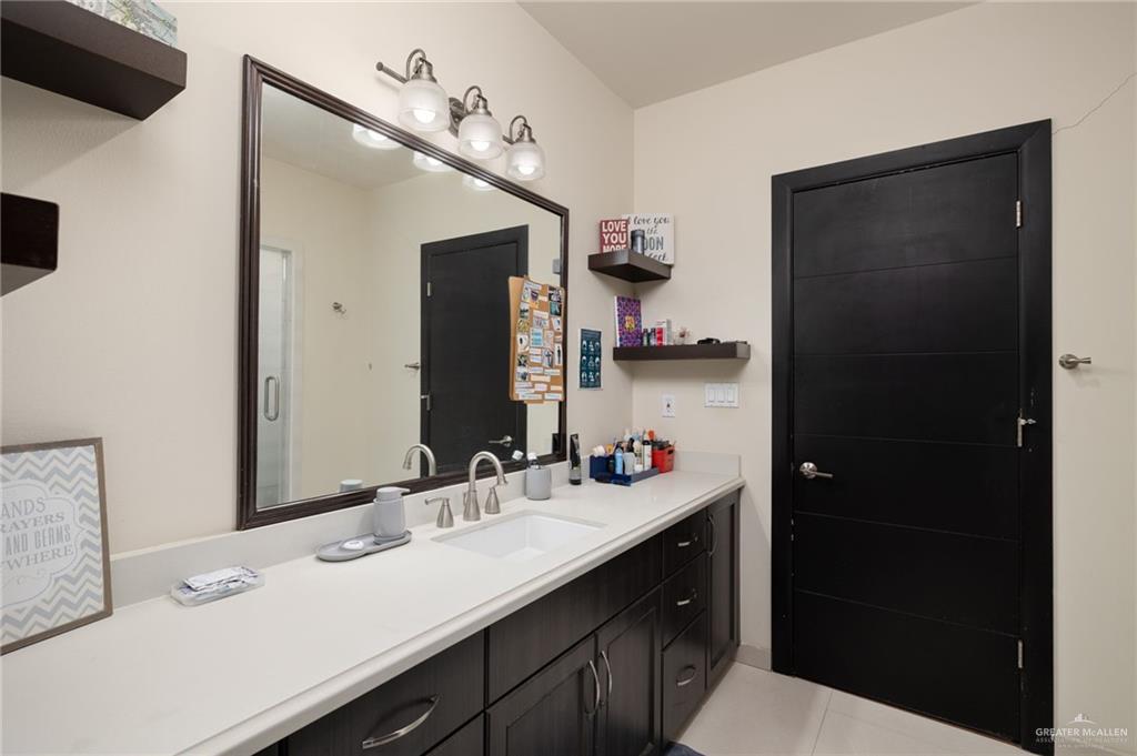 809 Rio Grande Drive Mission, TX 78572 - Photo 24 of 43 a bathroom with a sink vanity and a mirror