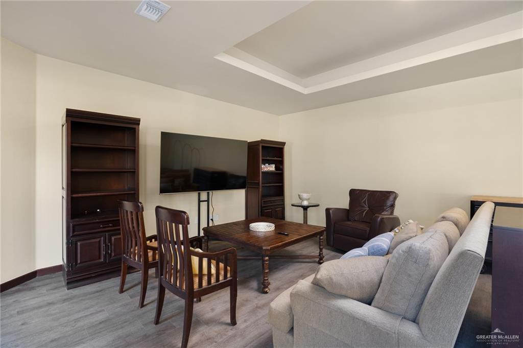 809 Rio Grande Drive Mission, TX 78572 - Photo 36 of 43 a living room with furniture and a flat screen tv