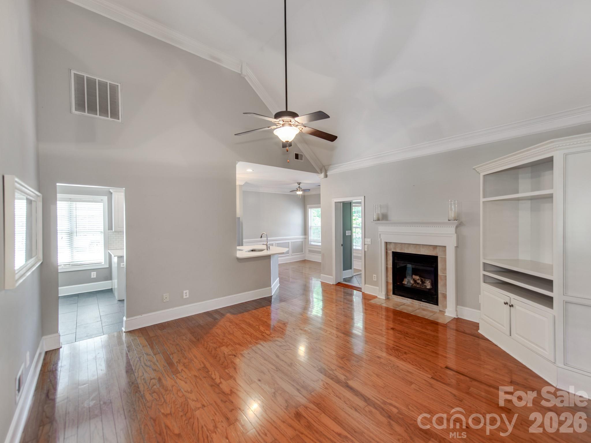 783 Sloan Street Denver, NC 28037 - Photo 4 of 44 a view of an empty room with a fireplace and a window