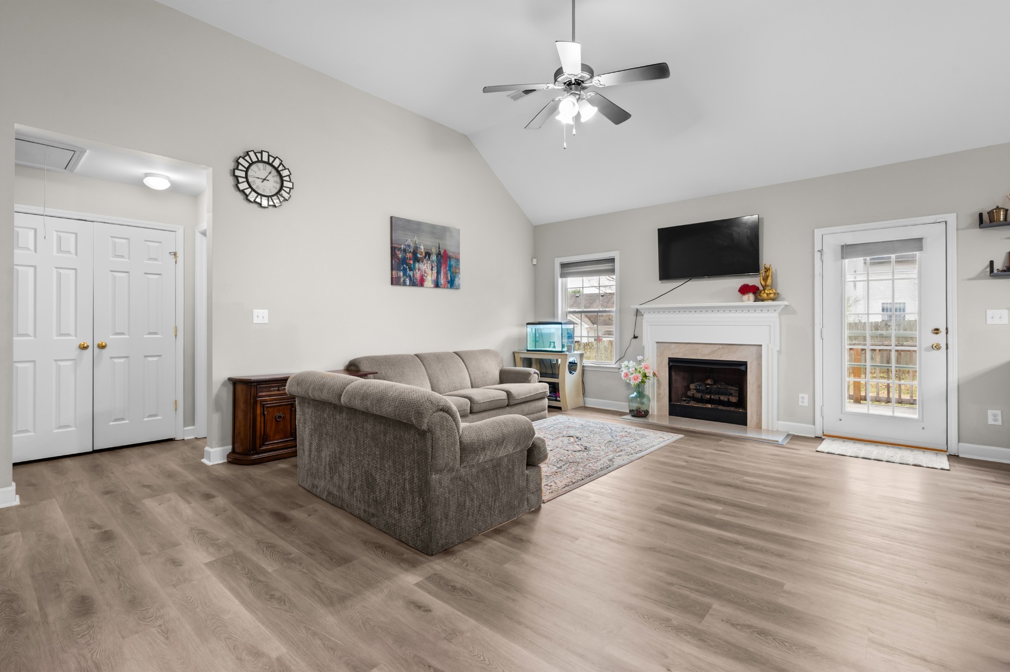 2601 Danbury Circle Spring Hill, TN 37174 - Photo 2 of 31 a living room with furniture a fireplace and a flat screen tv