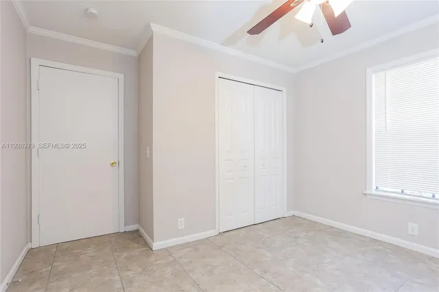 an empty room with windows and closet