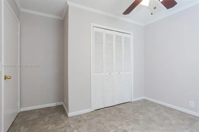 an empty room with a ceiling fan
