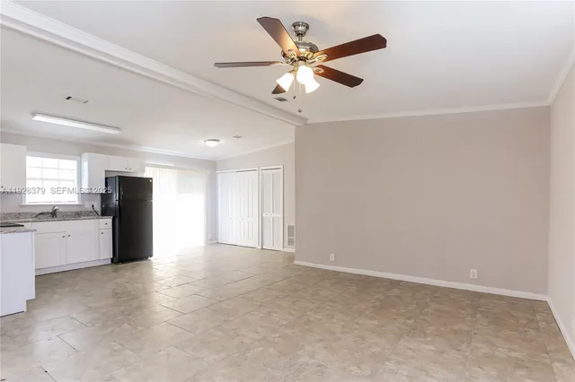 a view of a kitchen with a sink and a ceiling fan