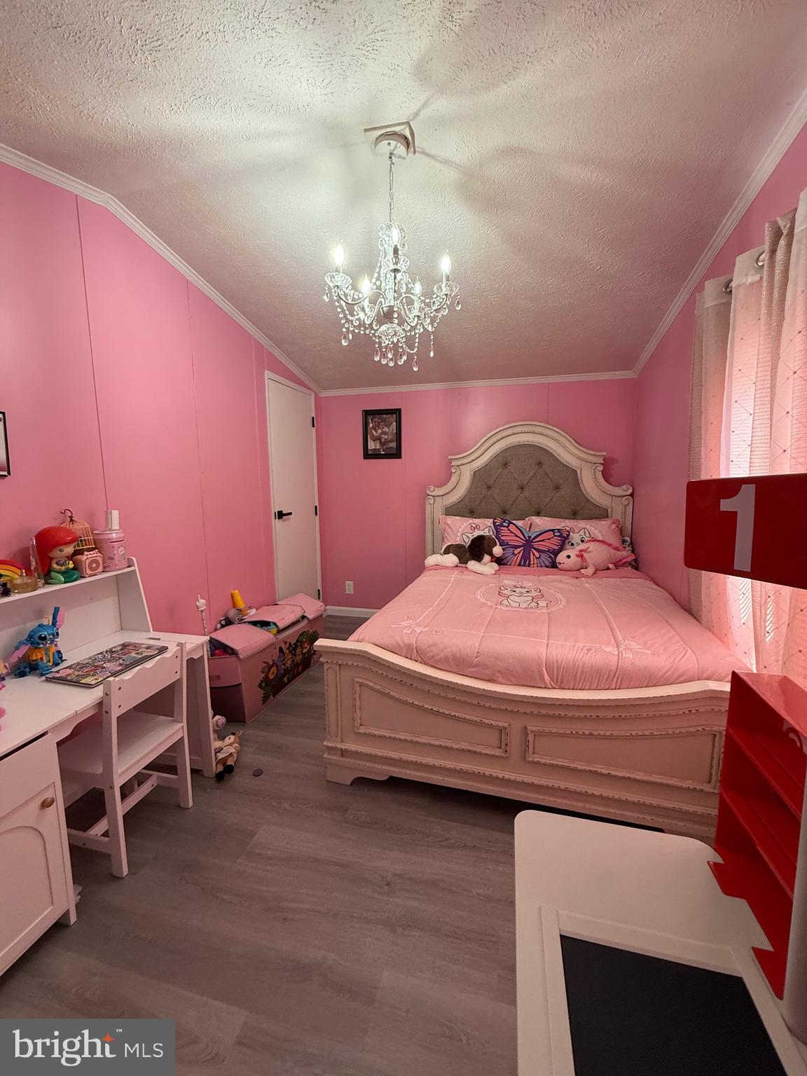 7959 Telegraph Road Severn, MD 21144 - Photo 8 of 18 a bedroom with a bed and a chandelier