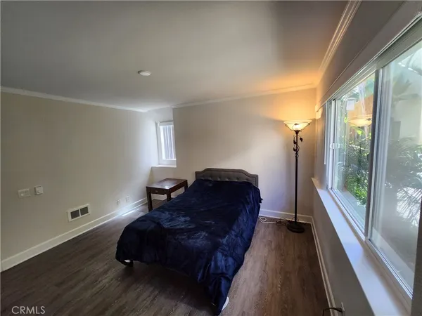 a spacious bedroom with a bed and a large window