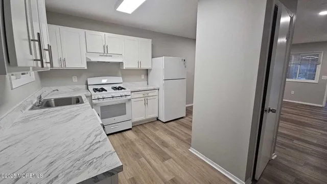 a kitchen with a stove a sink and a refrigerator