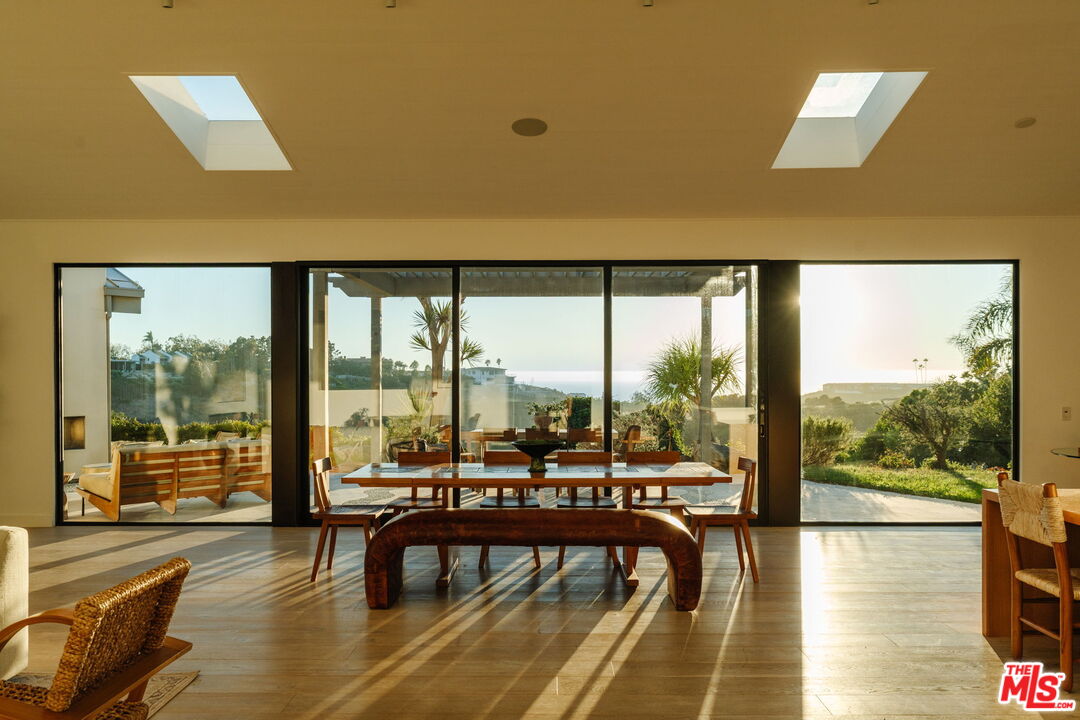 a view of a city from a dining room with furniture and window