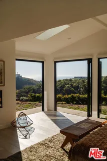 a bedroom with a bed and glass window