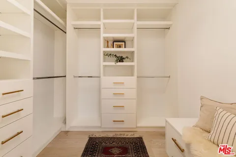 a bedroom with furniture and a wooden floor
