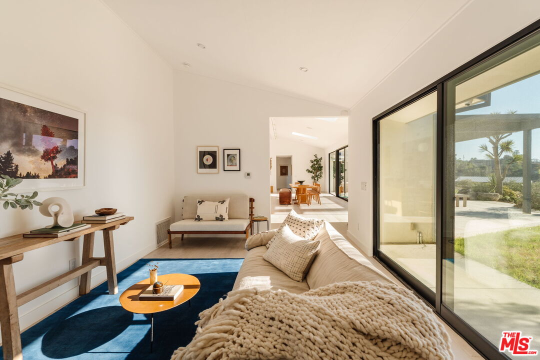 6767 Wandermere Road Malibu, CA 90265 - Photo 23 of 46 a bedroom with furniture and a wooden floor