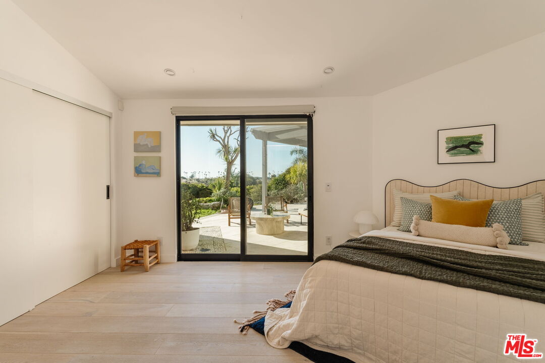 6767 Wandermere Road Malibu, CA 90265 - Photo 24 of 46 a bedroom with a bed and a large window