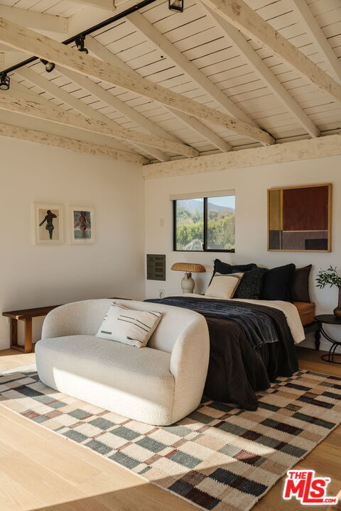 6767 Wandermere Road Malibu, CA 90265 - Photo 29 of 46 a large bed sitting in a bedroom next to a window