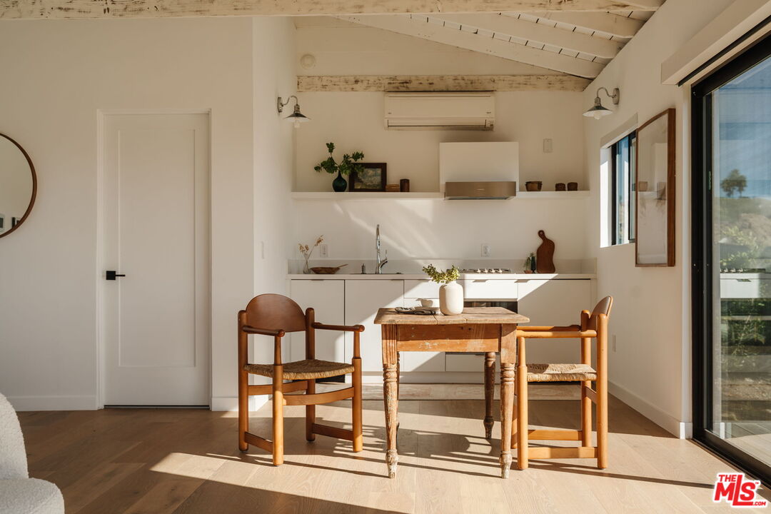 6767 Wandermere Road Malibu, CA 90265 - Photo 30 of 46 a dining room with furniture and wooden floor