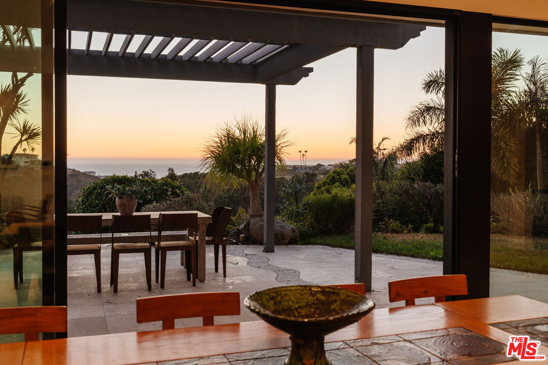 6767 Wandermere Road Malibu, CA 90265 - Photo 3 of 46 a view of a patio with a table chairs and a potted plant