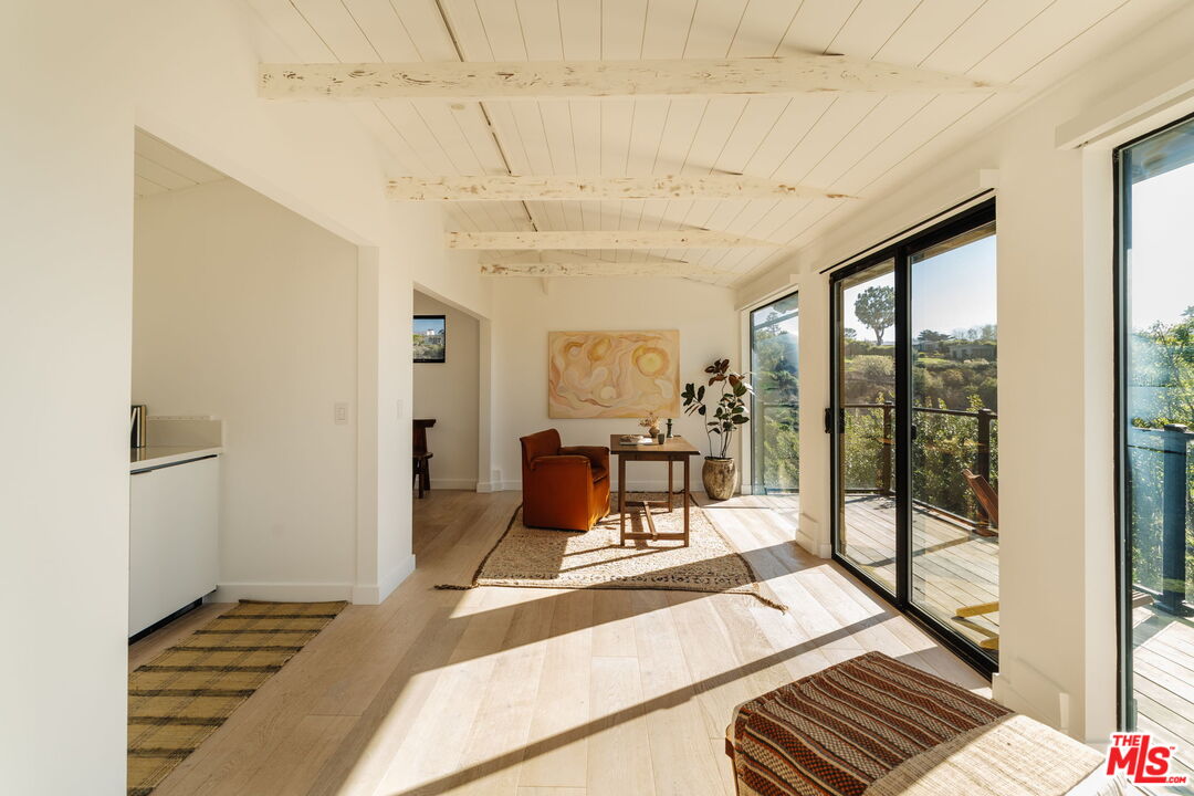 6767 Wandermere Road Malibu, CA 90265 - Photo 32 of 46 a living room with a furniture and next to a window
