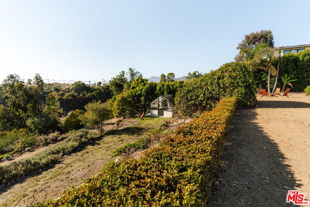 6767 Wandermere Road Malibu, CA 90265 - Photo 36 of 46 a view of a water with a mountain in the background