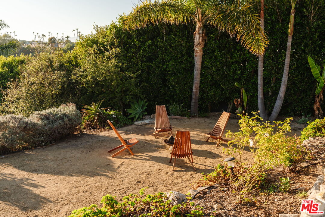 6767 Wandermere Road Malibu, CA 90265 - Photo 37 of 46 a backyard of a house with table and chairs