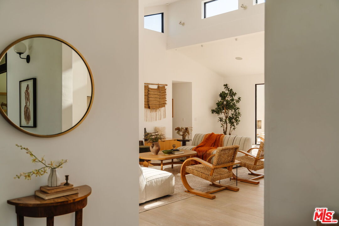 6767 Wandermere Road Malibu, CA 90265 - Photo 7 of 46 a living room with furniture and a mirror