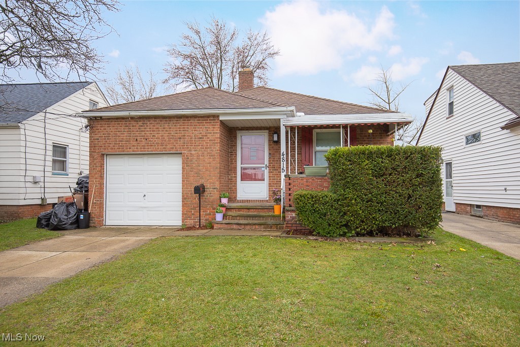 View of front of home with one car attached garage and porch