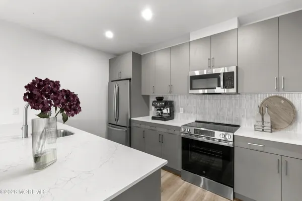 a kitchen with a sink stainless steel appliances and cabinets