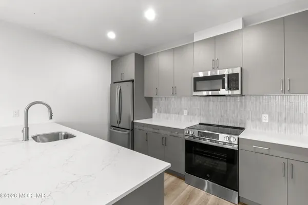 a kitchen with a sink appliances and cabinets