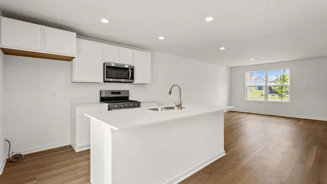 a kitchen with a stove and a microwave