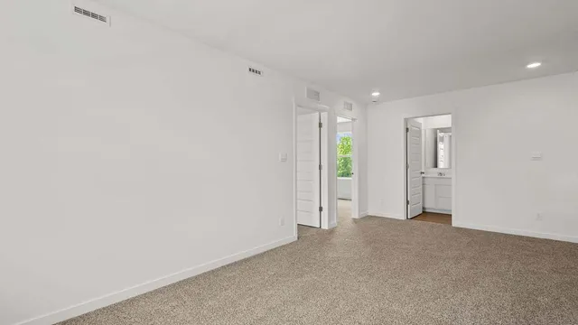 a view of an empty room and a window