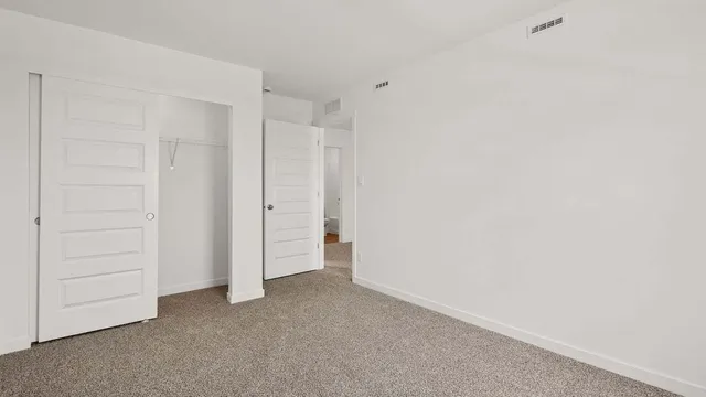 an empty room with closet area