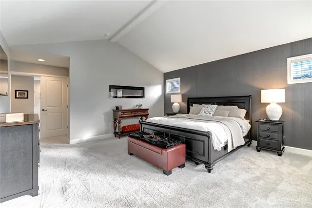 a bedroom with a bed and a view of kitchen