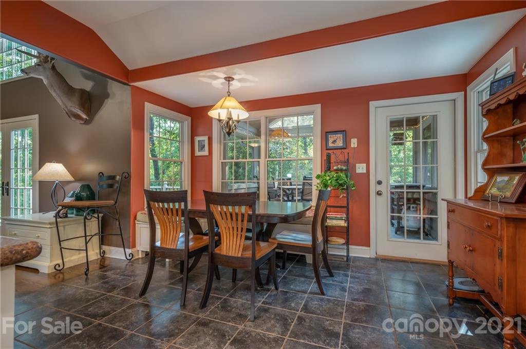 1426 Hayes Road Columbus, NC 28722 - Photo 16 of 45 a dining room with furniture and a floor to ceiling window