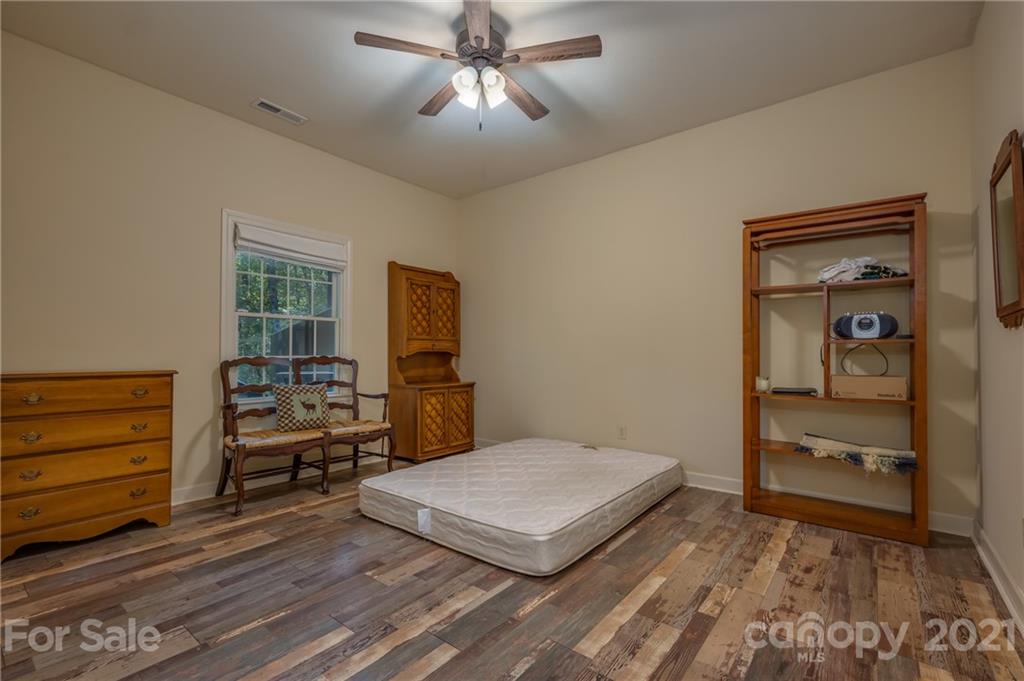 1426 Hayes Road Columbus, NC 28722 - Photo 28 of 45 a bedroom with a bed and a flat tv screen on dresser