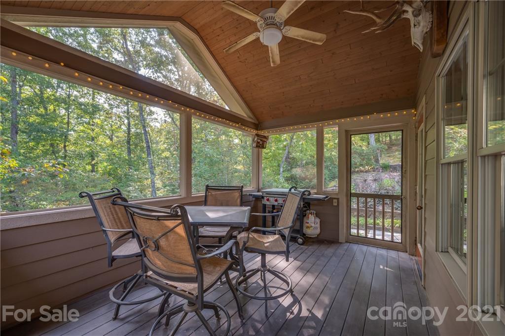 1426 Hayes Road Columbus, NC 28722 - Photo 36 of 45 a view of a patio with table and chairs and wooden floor