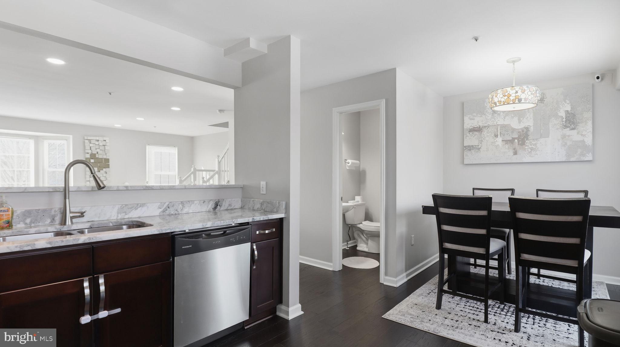 15922 Edgeview Terrace Bowie, MD 20716 - Photo 20 of 41 a kitchen with granite countertop a sink cabinets and stainless steel appliances