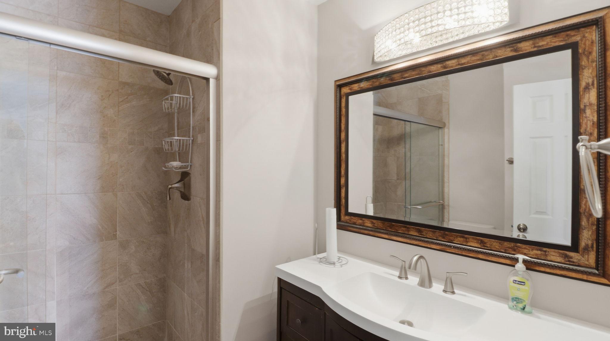 15922 Edgeview Terrace Bowie, MD 20716 - Photo 29 of 41 a bathroom with a sink and a mirror