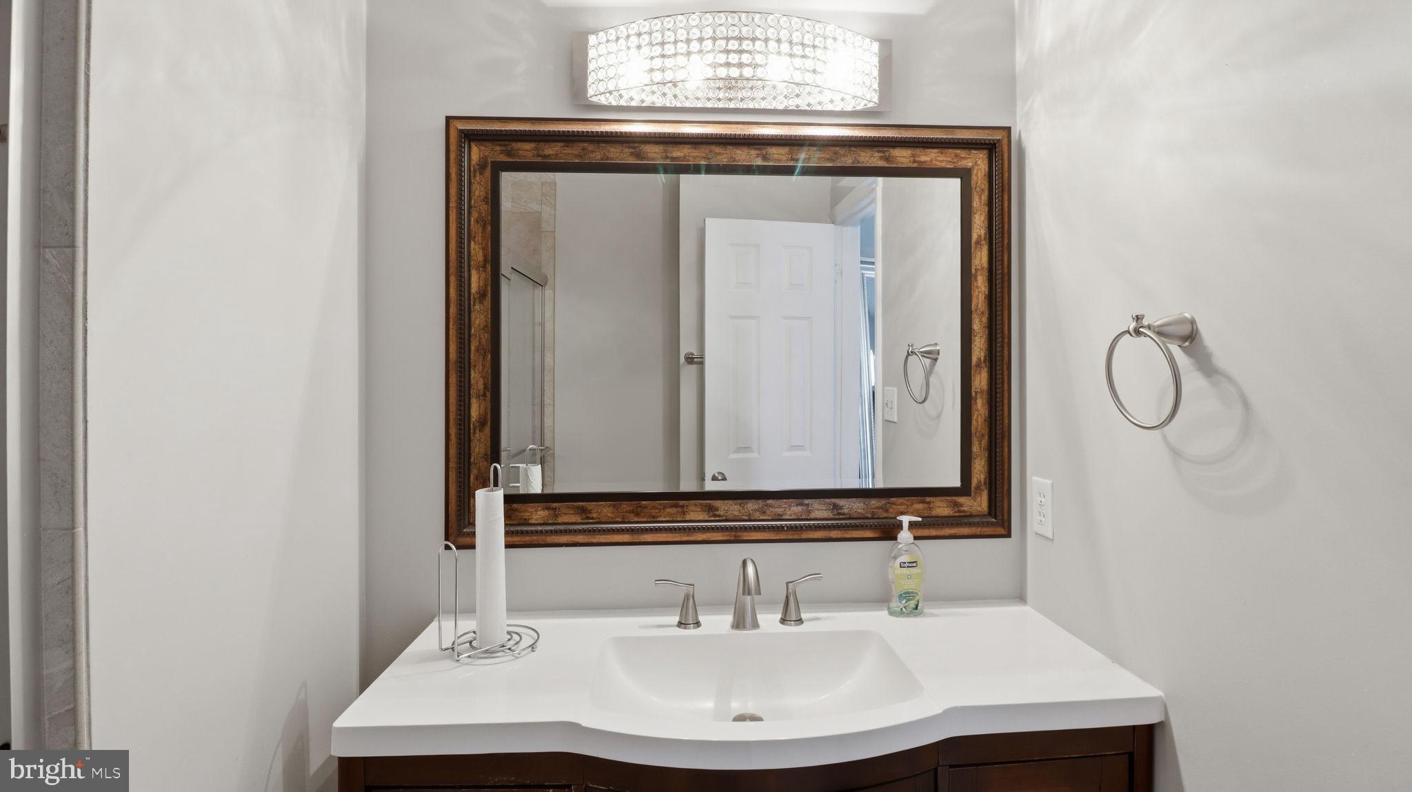 15922 Edgeview Terrace Bowie, MD 20716 - Photo 31 of 41 a bathroom with a sink and a mirror