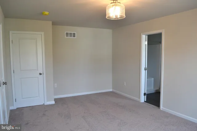 a view of an empty room with a chandelier