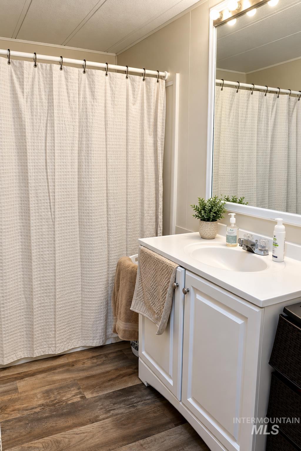 198 South Hills Road, Unit 52 Twin Falls, ID 83301 - Photo 12 of 22 White vanity with integrated sink, chrome faucet, and panel-front cabinetry
