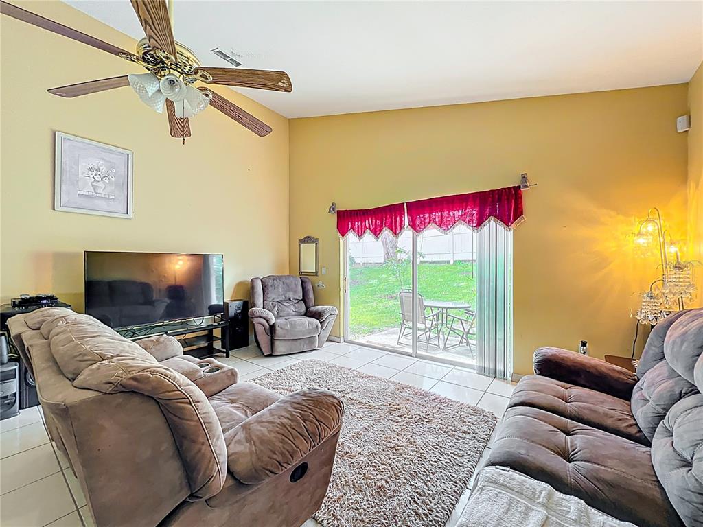 7939 Riffle Lane Orlando, FL 32818 - Photo 17 of 52 a living room with furniture and a flat screen tv