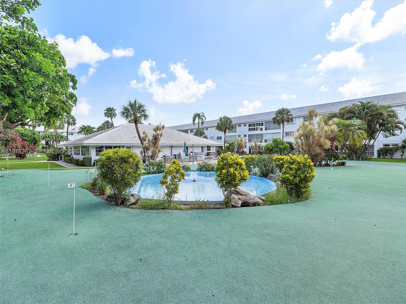 2050 Northeast 39th Street, Unit W212 Lighthouse Point, FL 33064 - Photo 12 of 17 a view of a garden with houses