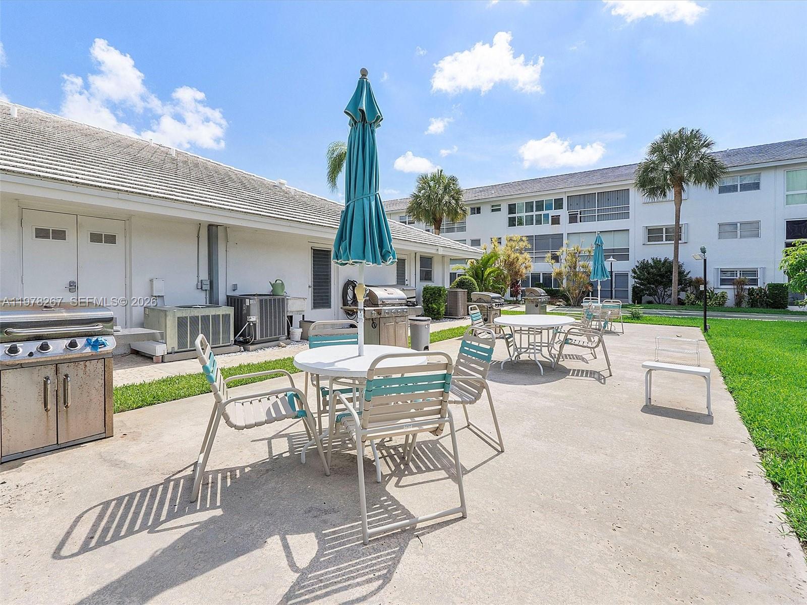 2050 Northeast 39th Street, Unit W212 Lighthouse Point, FL 33064 - Photo 14 of 17 a view of a house with backyard porch and sitting area