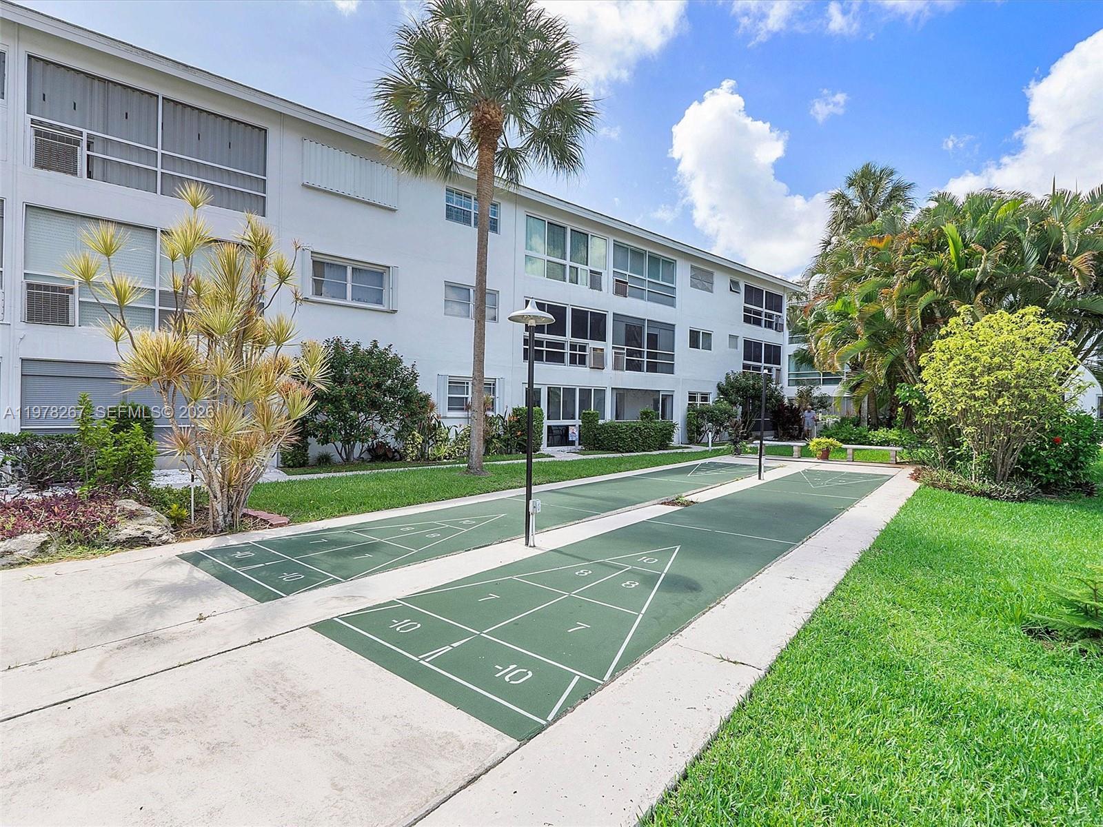 2050 Northeast 39th Street, Unit W212 Lighthouse Point, FL 33064 - Photo 15 of 17 a view of a house with a yard