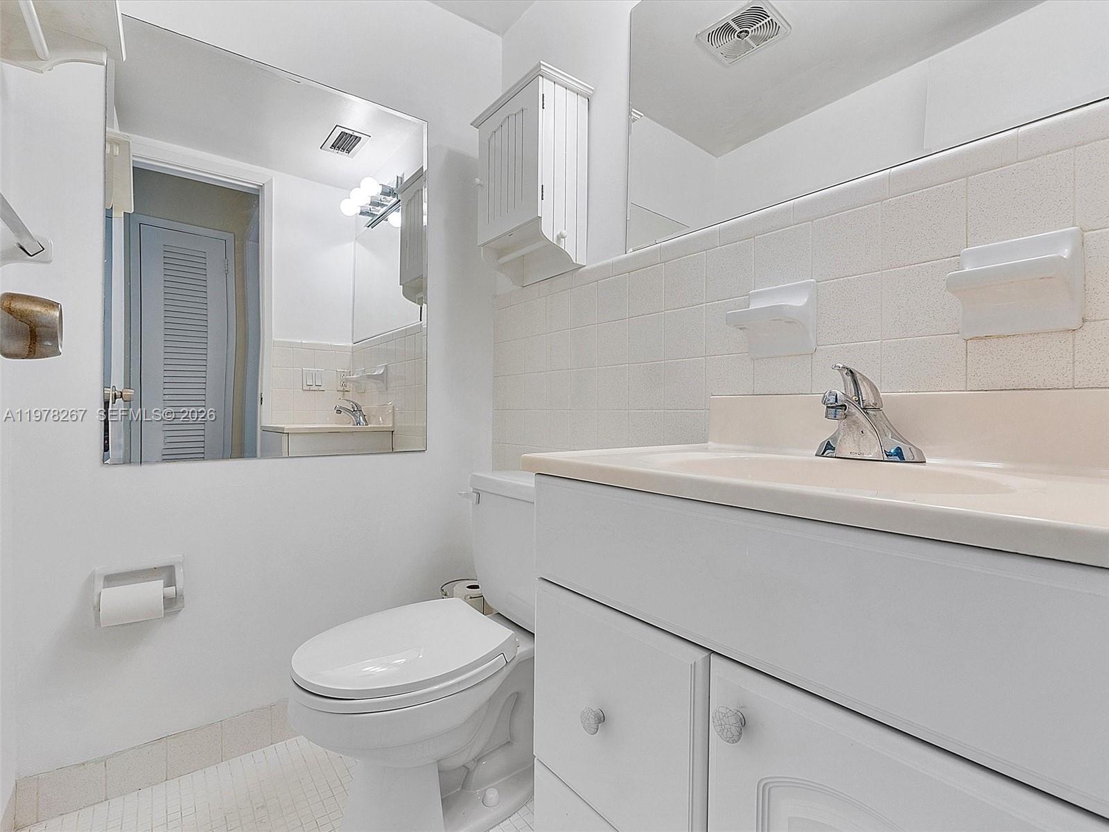 2050 Northeast 39th Street, Unit W212 Lighthouse Point, FL 33064 - Photo 4 of 17 a bathroom with a sink a toilet and shower