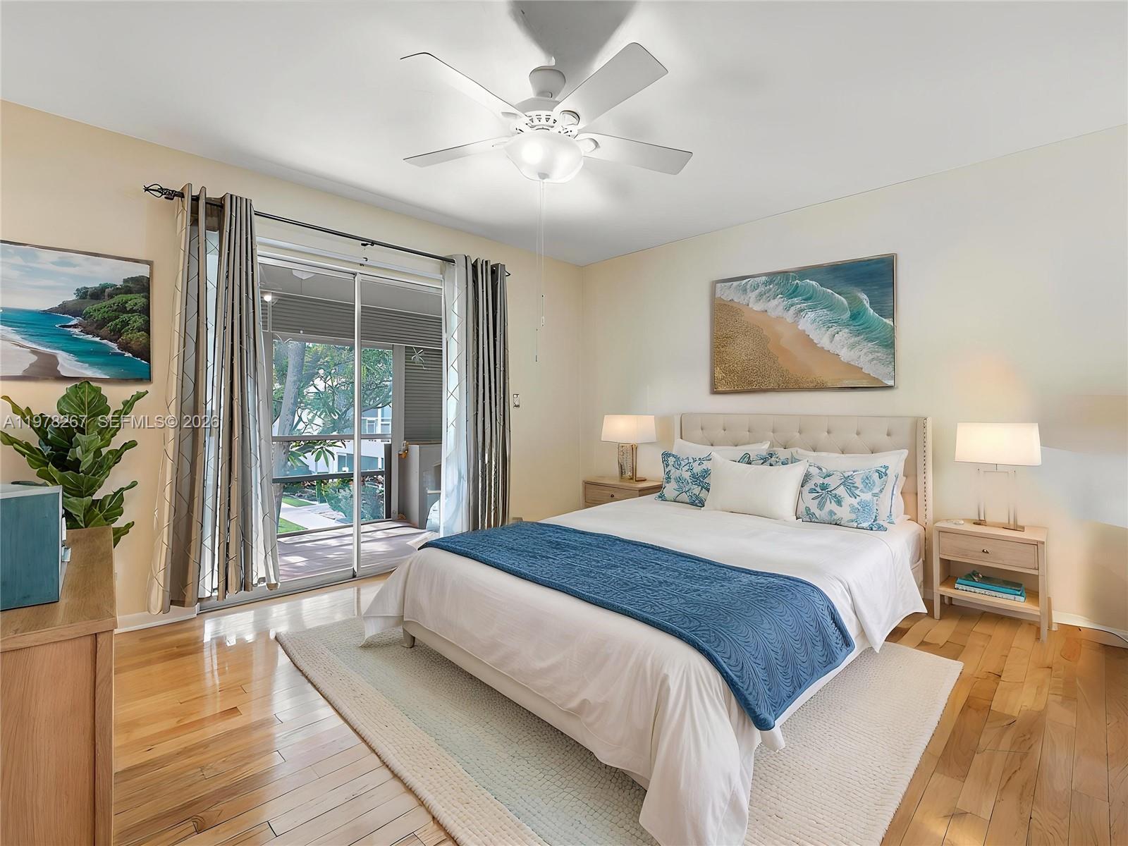 2050 Northeast 39th Street, Unit W212 Lighthouse Point, FL 33064 - Photo 5 of 17 a bedroom with a large bed and a chandelier