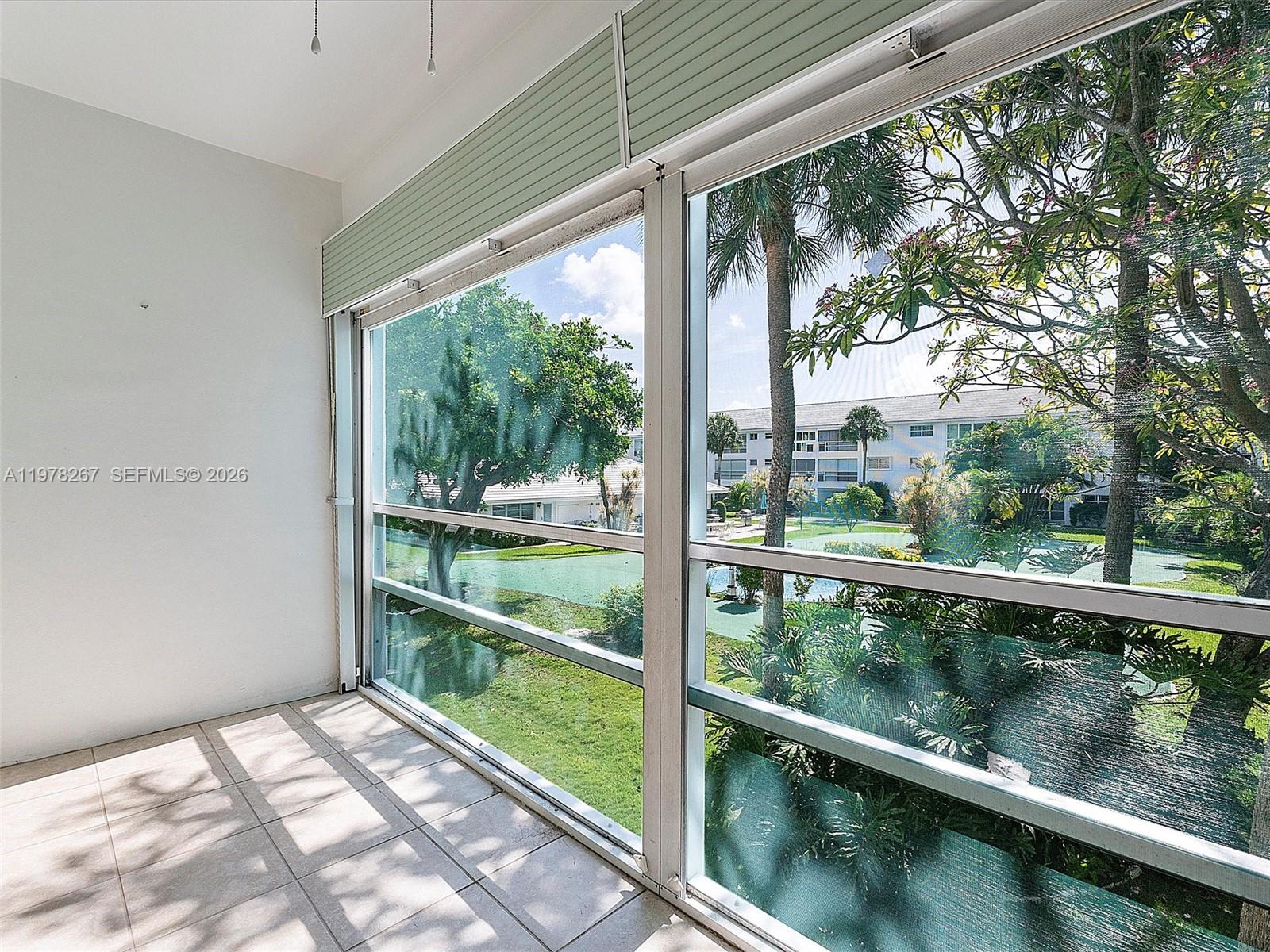 2050 Northeast 39th Street, Unit W212 Lighthouse Point, FL 33064 - Photo 8 of 17 a view of balcony with yard