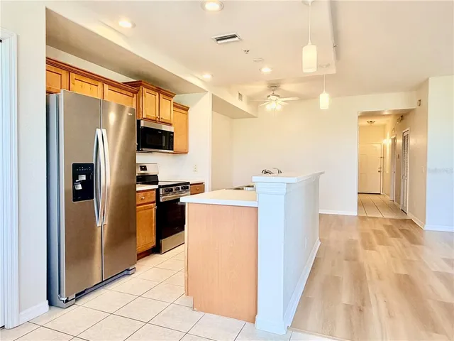 an empty room with a window and wooden floor