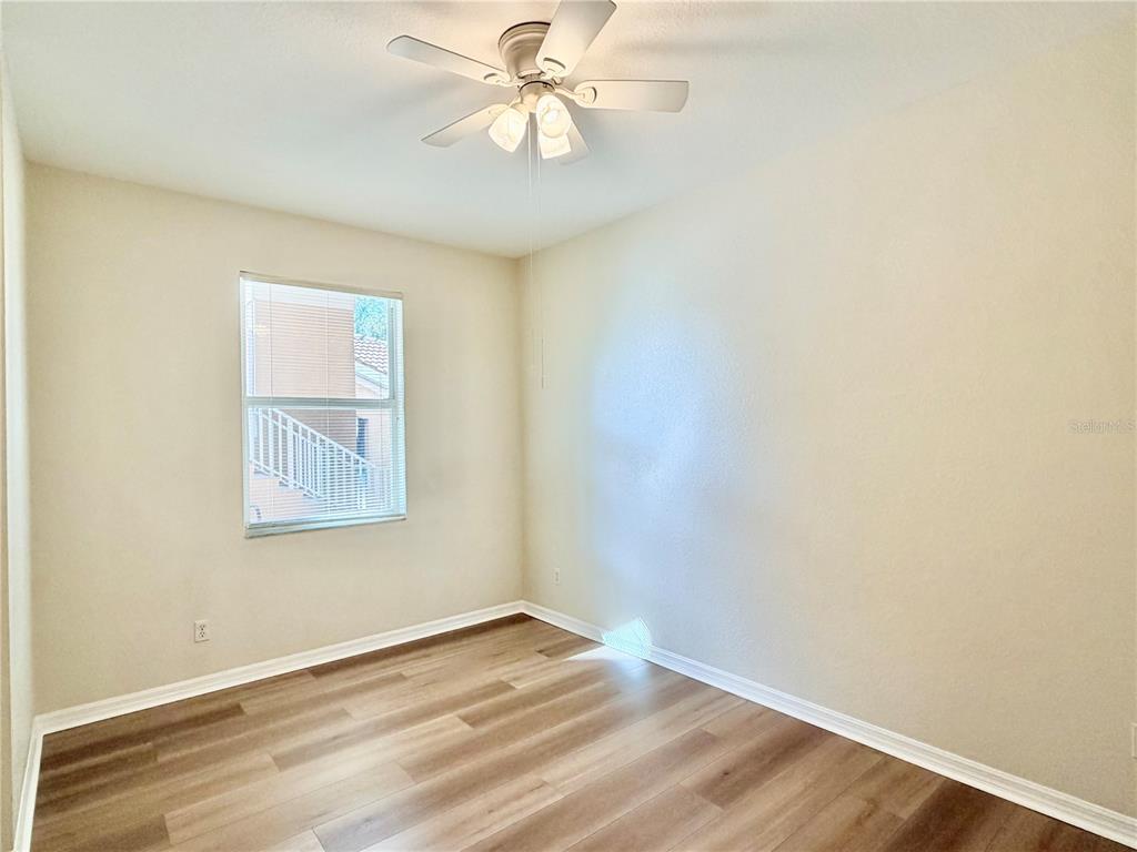 819 Fairwaycove Lane, Unit 102 Bradenton, FL 34212 - Photo 23 of 56 an empty room with a window and wooden floor