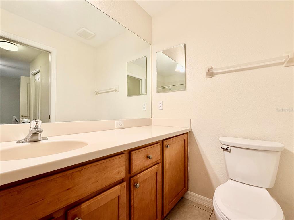 819 Fairwaycove Lane, Unit 102 Bradenton, FL 34212 - Photo 31 of 56 a bathroom with a toilet sink and mirror