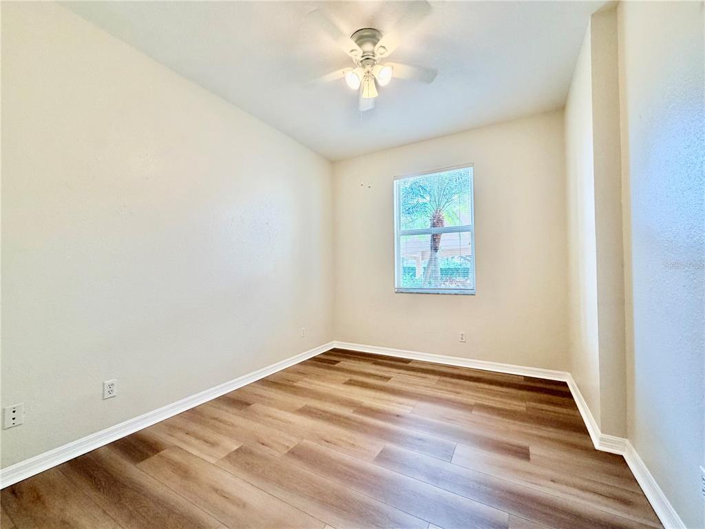 819 Fairwaycove Lane, Unit 102 Bradenton, FL 34212 - Photo 34 of 56 a view of empty room with wooden floor and fan