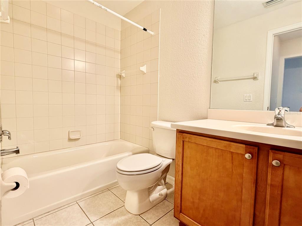 819 Fairwaycove Lane, Unit 102 Bradenton, FL 34212 - Photo 36 of 56 a bathroom with a sink a toilet and a bathtub