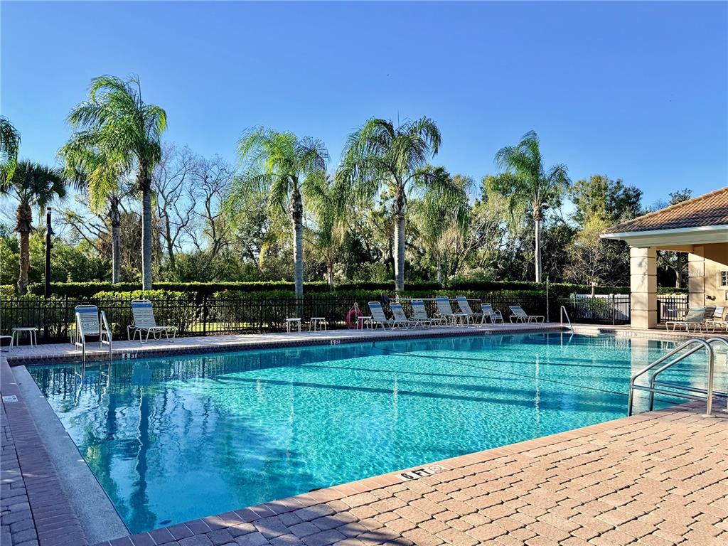 819 Fairwaycove Lane, Unit 102 Bradenton, FL 34212 - Photo 43 of 56 a view of a house with swimming pool and a yard